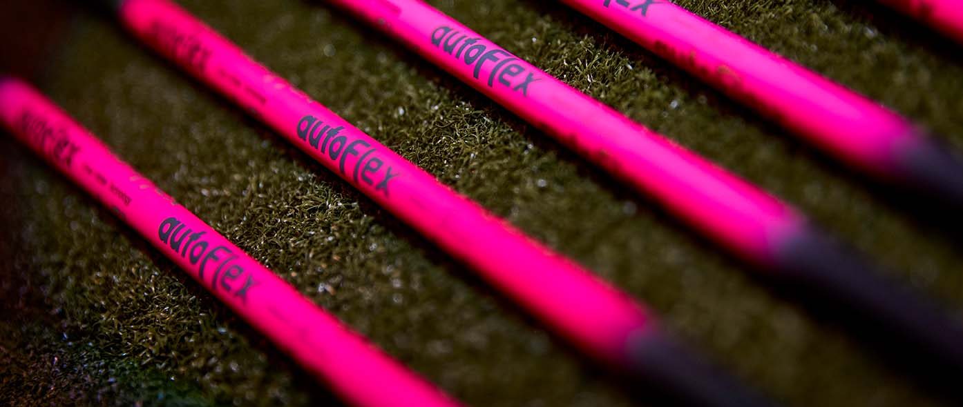 Detail shot of the black and pink Autoflex golf shafts laying next to each other.