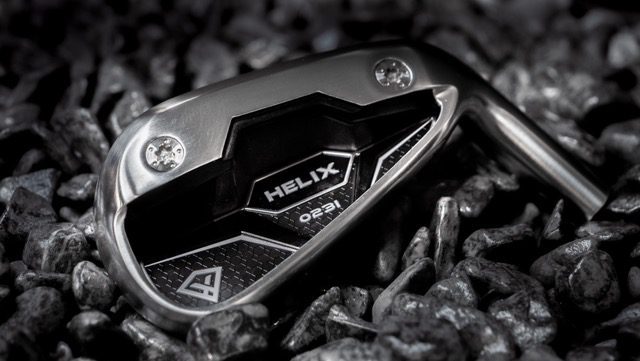 Image showing the Helix 023i iron being displayed on black gravel stones.